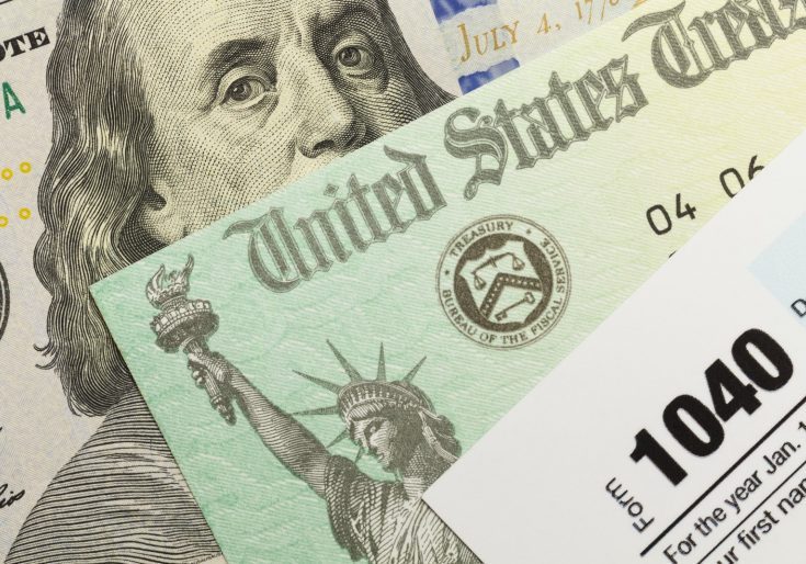An image of a united states tax bill and a us dollar bill.